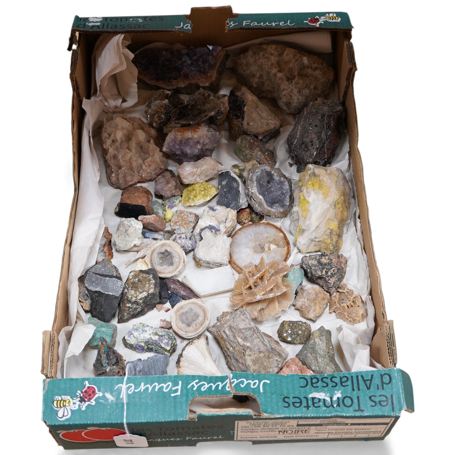 A collection of mineral and crystal samples, including large quartz segments and a good variety of other crystal formations